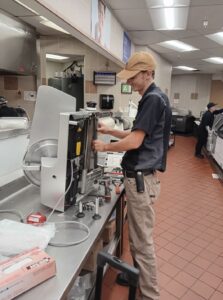 Brandon working on a meat slicer.