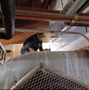 Pete re-sheeting a cooling tower.