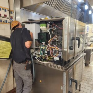 Brandon working on a Rational oven.